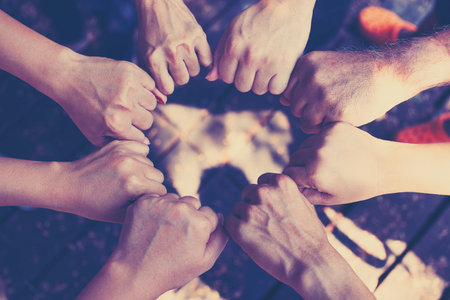 Concept of teamwork: Close-Up of hands business team showing unity with putting their hands together.の写真素材