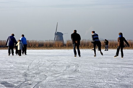 Ice skating on a cold winterday on a frozen lake in the Netherlands  の写真素材