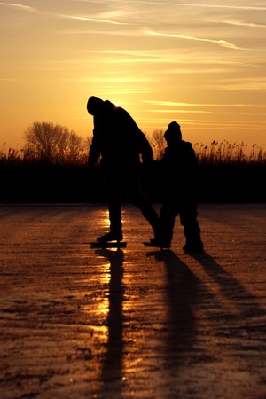 Ice skating at sunset in the Netherlandsの写真素材