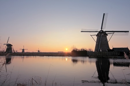 Old dutch windmills at sunset in the Netherlandsの写真素材