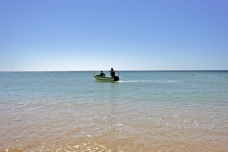 Fisherboat on the ocean at Armacao de Pera in the Algarve in Portugalの写真素材