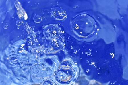 Clean water pouring in a blue bucket 