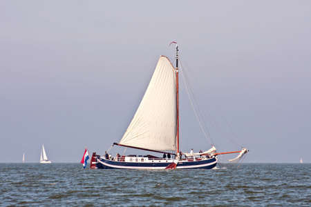 Traditional sailboat sailing on the IJsselmeer in the Netherlands の写真素材