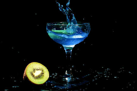 Blue cocktail splash with kiwi fruit の写真素材
