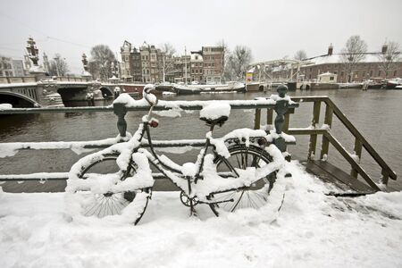 Snowy bicycle in Amsterdam city center the Netherlandsの写真素材
