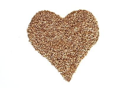 Heart of wheat grains on a white backgroundの写真素材