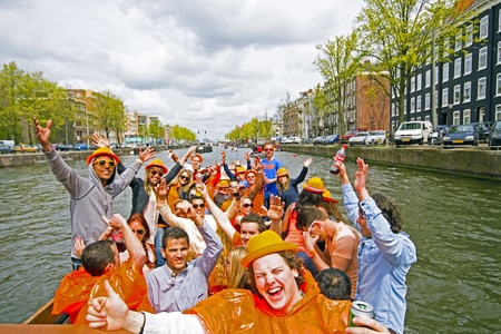 AMSTERDAM, NETHERLANDS - APRIL 30, 2013 : People in orange cruising through the canals from Amsterdam during the coronation of the new king Willem Alexander from the Netherlands.のeditorial素材