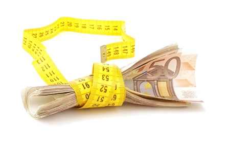 euro banknotes with measure tape on white backgroundの写真素材