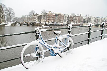 Bicycle in Amsterdam the Netherlands covered in snowの写真素材