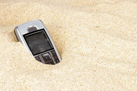 Mobile phone in the sandの写真素材