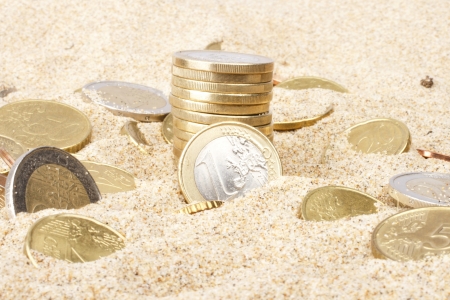 Euro coins in the sandの写真素材