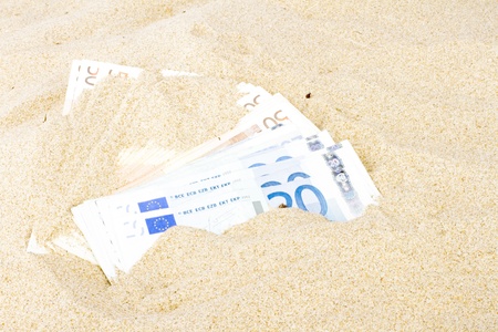 Euro banknotes in the sandの写真素材