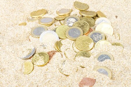 Euro coins in the sandの写真素材