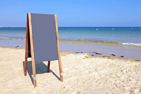 Blackboard sign at the beachの写真素材