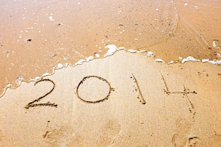 Happy New Year, 2014 written in sand at the beachの写真素材