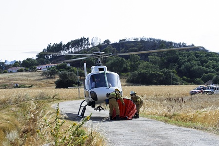 ALJEZUR - JULY 6  Firefighters fighting a huge bushfire in the national park near Aljezur on 6th july 2013 in Portugalのeditorial素材