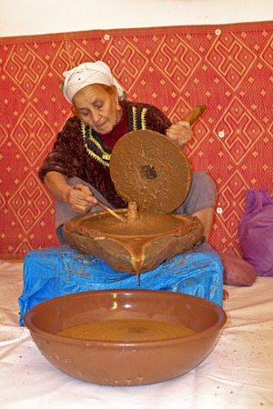 MOROCCO, OURIKA VALLEY - OCTOBER 24: Woman works in a cooperative for the manufacturing of argan oil on October 24, 2013 in Ourika valley, Moroccoのeditorial素材