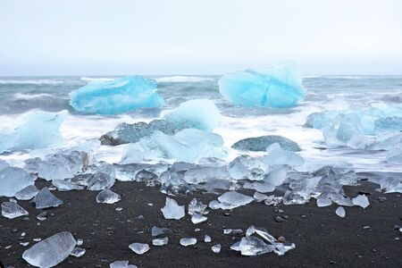 Ice rocks on a black sand beach in Icelandの写真素材