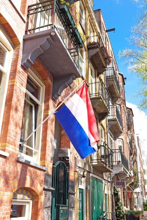 Traditional dutch house decorated with the national flag on Kingsday in Amsterdam the Netherlandsのeditorial素材