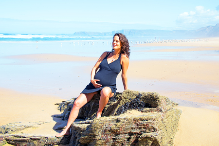 Pregnant woman on the beach at the atlantic oceanの写真素材