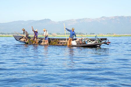 INLE LAKE, MYANMAR - NOVEMBER 23, 2015: Local workers collecting weed from the fresh water on Inle Lake, Myanmar on the 23th November, 2015.のeditorial素材