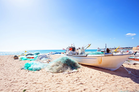 Old fisher boat at the beach at Armacao de Pera in Portugalの写真素材