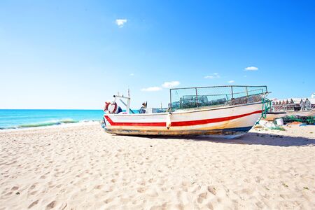 Old fisher boat at the beach at Armacao de Pera in Portugalの写真素材