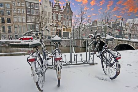 Sunset in snowy Amsterdam Netherlands in winterの写真素材