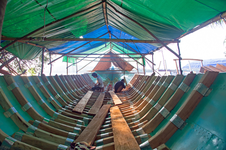 LOMBOK, INDONESIA - JANUARY 1, 2017: Workers building a boat in a traditional way on Gili Meno, Indonesia on the 1st of january 2017のeditorial素材