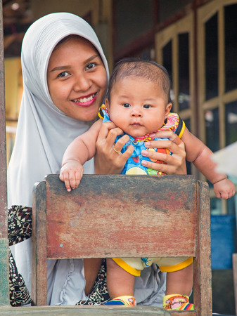 LOMBOK, INDONESIA - DECEMBER 30, 2016: Typically indonesian mother with her little baby in Lombok, Indonesia on the 30th of december 2016のeditorial素材
