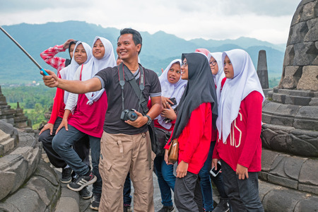 JAVA, INDONESIA - DECEMBER 16, 2016: Making a selfie during visiting Prambanan or Candi Rara Jonggrang, a Hindu temple compound in Java, Indonesia, dedicated to the Trimurti: the Creator (Brahma), the Preserver (Vishnu) and the Destroyer (Shiva) on the 16のeditorial素材