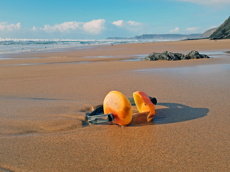 Ear muffs lying on the beachの写真素材