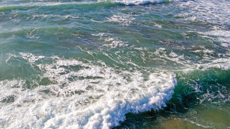 Aerial from ocean waves hitting the shore from the westcoast in Portugal