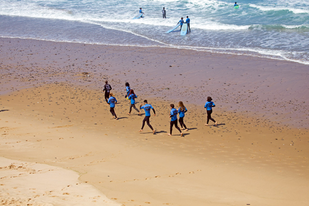 VALE FIGUEIRAS, PORTUGAL - JULY 19, 2018: Aerial from surfers getting surfers lessons at Praia Vale Figueieras in Portugalのeditorial素材