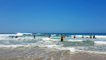 VALE FIGUEIRAS, PORTUGAL - JULY 19, 2018: Surfers getting surfers lessons at Praia Vale Figueieras...