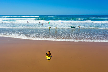 Vale Figueiras, Portugal - 25th may 2019: Aerial from surfers getting surfing lessons in the ocean