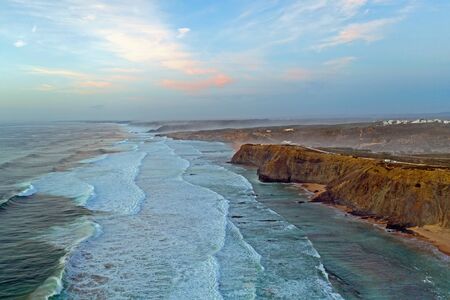 Aerial from the beach and ocean at Monte Clerigo in Portugal at sunsetの写真素材