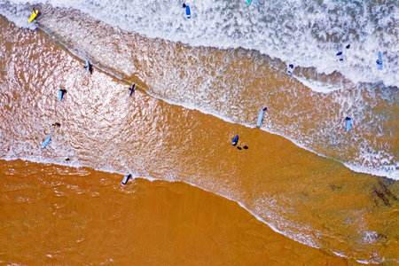 Top shot from surfers getting surfers lessons in the atlantic oceanの写真素材