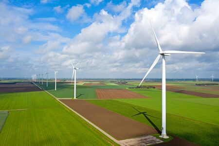 Aerial from a dutch landscape with windturbines, meadows and beautiful skiesの写真素材