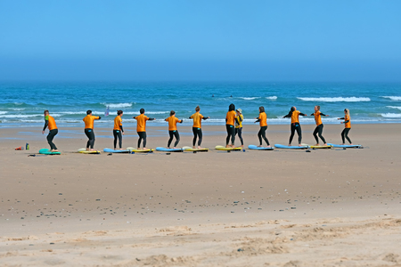 Vale Figueiras, Portugal - April 8, 2019: Surfers getting surfers lessons in Portugalのeditorial素材