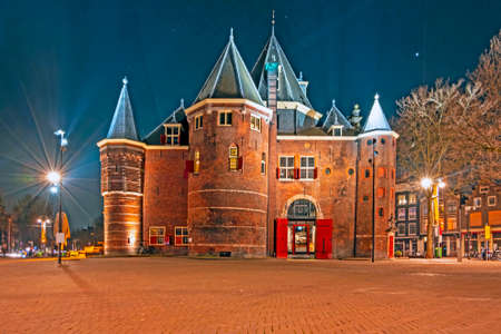 City scenic from Amsterdam in the Netherlands with the Waag building at nightのeditorial素材