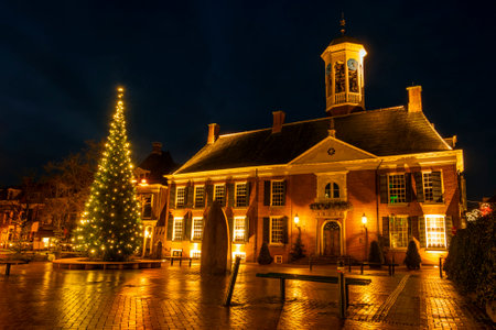 Medieval city hall from Dokkum in the Netherlands at night in christmas timeのeditorial素材