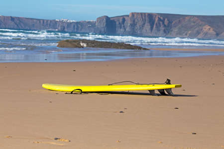 Surfboard lying on the beach in Portugalの写真素材