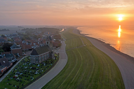 Aerial from the village Wierum at the Wadden Sea in the Netherlands at sunsetの写真素材