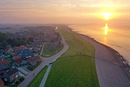 Aerial from the village Wierum at the Wadden Sea in the Netherlands at sunsetの写真素材