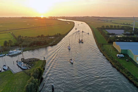Aerial from sailing boats at sunset in Friesland the Netherlandsの写真素材