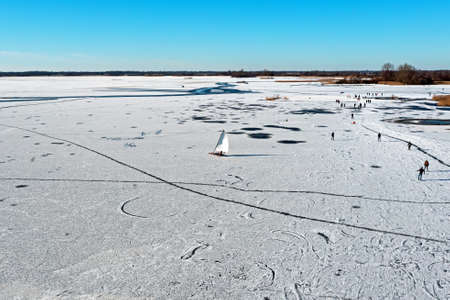Aerial from ice sailing and skating on Bergumer lake in winter in Friesland the Netherlandsの写真素材