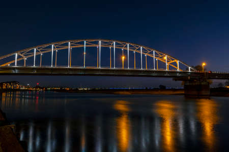 The Wilhelmina bridge at the river IJssel near Deventer in the Netherlands at nightの写真素材