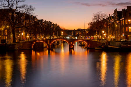 City scenic from Amsterdam at the river Amstel in the Netherlands at sunsetの写真素材