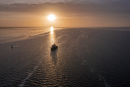Aerial from a beautiful sunset at the Wadden Sea in Friesland the Netherlands